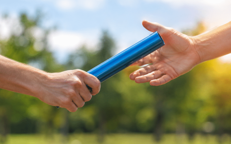 running baton being handed over